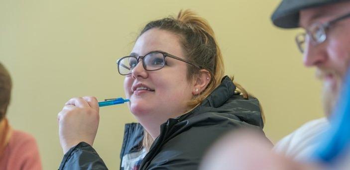 A student participating in class discussion